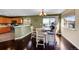 The dining area has hardwood floors, modern light fixture, and sliding glass doors to the patio at 7835 Canvasback Cir, Littleton, CO 80125