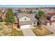 Charming two-story home with a well-manicured front lawn, a two-car garage and a fenced yard at 7835 Canvasback Cir, Littleton, CO 80125