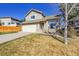 Two-story home boasts a two-car garage, front yard with mature tree and plentiful windows at 7835 Canvasback Cir, Littleton, CO 80125