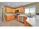 Well-lit kitchen features stainless steel appliances, ample counter space, and views from a window at 7835 Canvasback Cir, Littleton, CO 80125