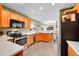 The kitchen features stainless appliances, a breakfast bar, and is open to other living spaces at 7835 Canvasback Cir, Littleton, CO 80125