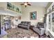 Bright living room featuring hardwood floors, vaulted ceiling, and large windows at 7835 Canvasback Cir, Littleton, CO 80125