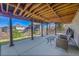 Covered patio with concrete flooring and exposed beam ceiling, offering a perfect spot for relaxing and enjoying the backyard at 7835 Canvasback Cir, Littleton, CO 80125