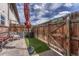 Charming fenced backyard with artificial turf and seating area at 3614 W Radcliff Ave, Denver, CO 80236