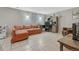 Comfortable finished basement featuring a sofa, desk, and tile floors at 3614 W Radcliff Ave, Denver, CO 80236