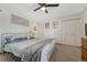 Bright bedroom featuring a ceiling fan, carpeted floor, and closet at 3614 W Radcliff Ave, Denver, CO 80236