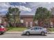 Charming brick townhouse with well-manicured lawn and sidewalk at 3614 W Radcliff Ave, Denver, CO 80236