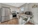 Updated kitchen with stainless steel appliances and granite countertops at 3614 W Radcliff Ave, Denver, CO 80236