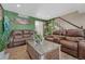 Spacious living room with leather sofas, wood floors, and staircase view at 3614 W Radcliff Ave, Denver, CO 80236