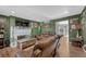 Spacious living room with fireplace, wood floors, and comfortable leather seating at 3614 W Radcliff Ave, Denver, CO 80236