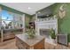 Bright living room with fireplace, wood floors, and modern decor at 3614 W Radcliff Ave, Denver, CO 80236