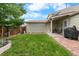 Lush backyard with grassy lawn, trees, grilling area, and patio at 113 Rockaway Ave, Castle Rock, CO 80104