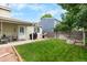 Backyard featuring a well-maintained lawn, grilling area, and fence at 113 Rockaway Ave, Castle Rock, CO 80104
