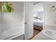 Bathroom featuring a soaking tub and a peek into the primary bedroom at 113 Rockaway Ave, Castle Rock, CO 80104