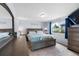 Well-lit bedroom with a comfortable bed, coordinated furnishings, and a large mirror at 113 Rockaway Ave, Castle Rock, CO 80104