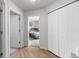Hallway with wood floors leading to bedroom with comfortable looking king bed at 113 Rockaway Ave, Castle Rock, CO 80104
