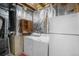 Functional laundry room with washer, dryer, shelving and insulated walls at 113 Rockaway Ave, Castle Rock, CO 80104
