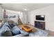 Inviting living room featuring a cozy fireplace and comfortable seating arrangement near the stairway at 113 Rockaway Ave, Castle Rock, CO 80104