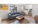 Basement living room with neutral tones, comfortable seating, large window, and laminate flooring at 113 Rockaway Ave, Castle Rock, CO 80104