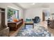 Cozy living room featuring a comfortable sofa, armchair, area rug and natural light from the window at 113 Rockaway Ave, Castle Rock, CO 80104