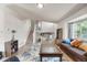 Bright living room with plush seating, blue patterned rug, wood floors, stairway and natural light at 113 Rockaway Ave, Castle Rock, CO 80104