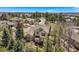 Aerial view of a charming home with a flagstone patio and lush landscaping surrounded by mature trees at 24487 E Frost Dr, Aurora, CO 80016