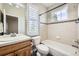 Bathroom with a tiled shower-tub, a decorative border and a sink with traditional fixtures at 24487 E Frost Dr, Aurora, CO 80016