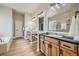 Bathroom featuring double sink vanity, soaking tub, glass shower and tile flooring at 24487 E Frost Dr, Aurora, CO 80016