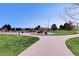 Scenic community park featuring walking paths, playground, grassy areas, and mature trees for outdoor activities at 24487 E Frost Dr, Aurora, CO 80016