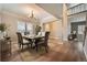 Elegant dining room with hardwood floors, modern chandelier, and neutral decor at 24487 E Frost Dr, Aurora, CO 80016
