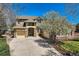 Charming two-story home showcasing a stone-accented facade, three-car garage, and beautifully landscaped front yard at 24487 E Frost Dr, Aurora, CO 80016