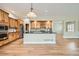 Modern kitchen featuring hardwood floors, an island, and sleek stainless steel appliances at 24487 E Frost Dr, Aurora, CO 80016