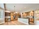 Spacious kitchen with custom wood cabinetry, granite countertops, and stainless steel appliances at 24487 E Frost Dr, Aurora, CO 80016