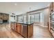 Kitchen island sink with an open view of stone fireplace and large windows with white shutters at 24487 E Frost Dr, Aurora, CO 80016