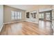 Bright and airy living room featuring hardwood floors, large windows, and a view of the fireplace at 24487 E Frost Dr, Aurora, CO 80016