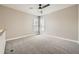 Carpeted loft area featuring a ceiling fan, neutral walls and two windows with plantation shutters at 24487 E Frost Dr, Aurora, CO 80016