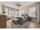 Beautifully staged bedroom with blue textiles, natural lighting, and wood accents at 24487 E Frost Dr, Aurora, CO 80016