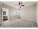 Spacious main bedroom features plush carpeting, a ceiling fan, and an adjoining bathroom at 24487 E Frost Dr, Aurora, CO 80016