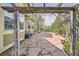 An expansive stone patio is connected to the house by a wooden pergola and features mature trees and a small garden at 24487 E Frost Dr, Aurora, CO 80016