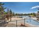 Community pools, playground and outdoor entertainment areas surrounded by mature trees and manicured landscaping at 24487 E Frost Dr, Aurora, CO 80016