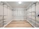 Walk-in closet featuring custom metal shelving and hardwood floors for storage at 24487 E Frost Dr, Aurora, CO 80016