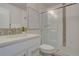 Bright bathroom featuring a shower with glass door, tile accents, and a white vanity at 5863 N Boston St, Denver, CO 80238