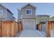 Contemporary home with a gray facade, a two-car garage, and well-maintained landscaping at 5863 N Boston St, Denver, CO 80238