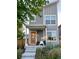 Charming gray two-story home with a welcoming front porch, colorful front yard flowers, and an orange front door at 5863 N Boston St, Denver, CO 80238