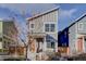 Two story grey home with modern architecture and a bright orange front door, set in a cozy neighborhood at 5863 N Boston St, Denver, CO 80238
