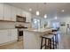 Spacious kitchen island featuring pendant lighting, seating, and a stainless steel dishwasher at 5863 N Boston St, Denver, CO 80238