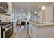 Bright, open-concept kitchen and dining area, complete with stainless steel appliances and wood flooring at 5863 N Boston St, Denver, CO 80238