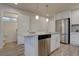 Modern kitchen with stainless steel appliances, granite countertops, and a kitchen island with sink and breakfast bar at 5863 N Boston St, Denver, CO 80238