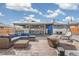 Outdoor entertaining area with ample seating, fire pit, and stylish decor at 6190 Garrison St, Arvada, CO 80004