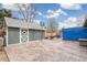 Large backyard patio features a shed, basketball hoop, seating area, and decorative concrete, great for recreation at 6190 Garrison St, Arvada, CO 80004